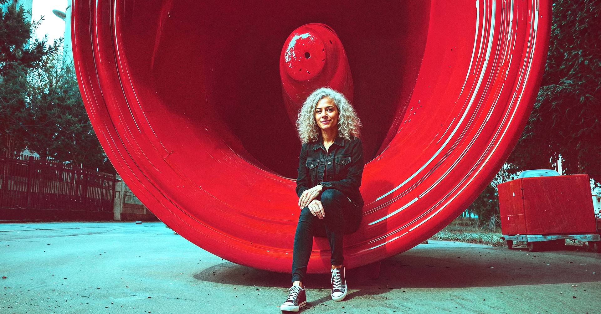 Woman sitting in a megaphone sculpture