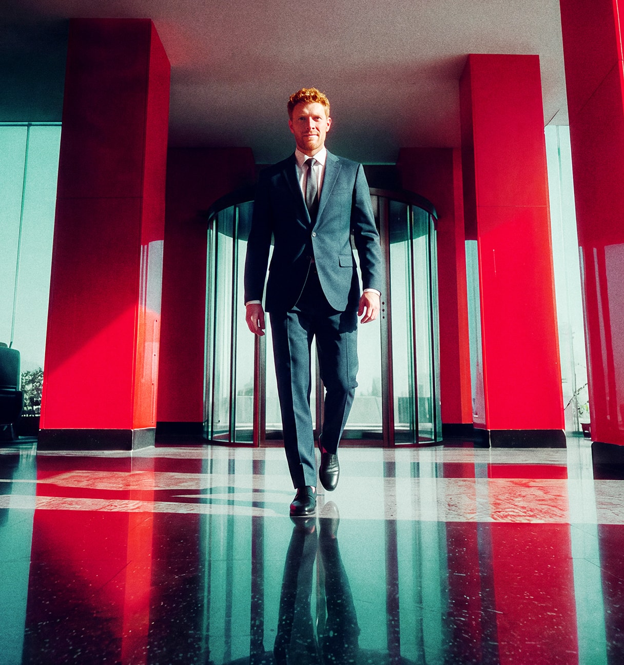 man in suit walking in a building
