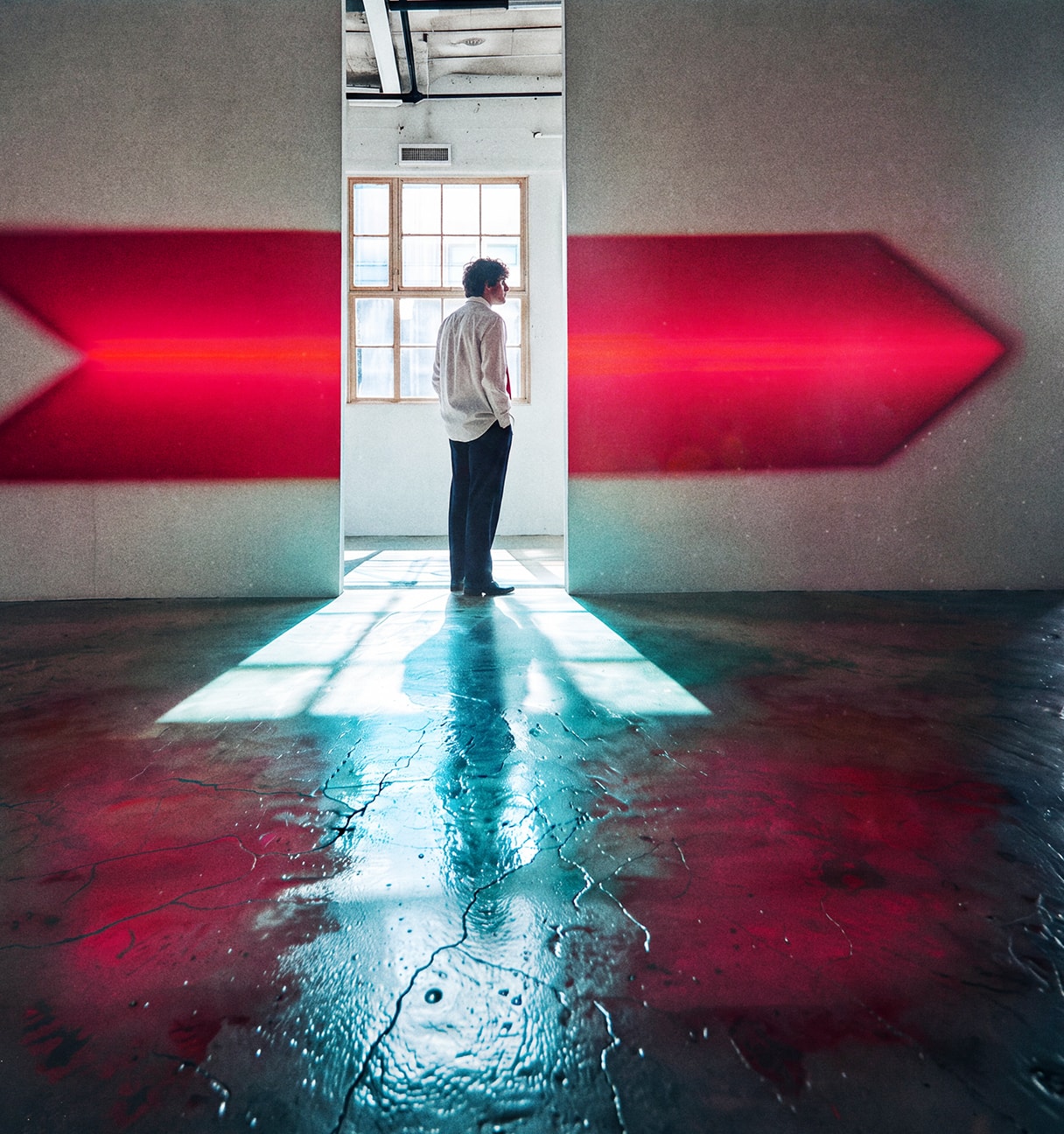 man following a red arrow to the right