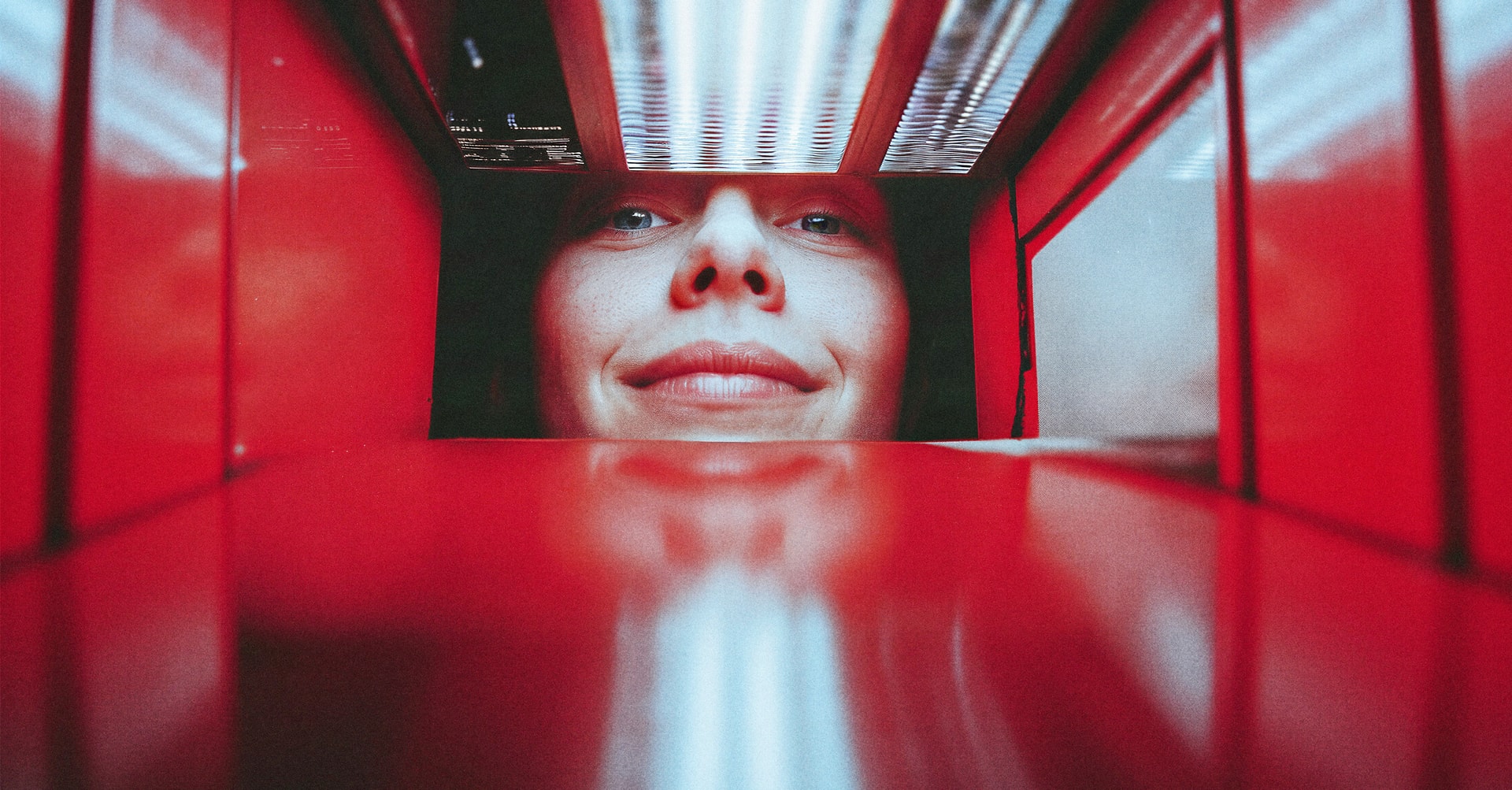 woman looking into red box