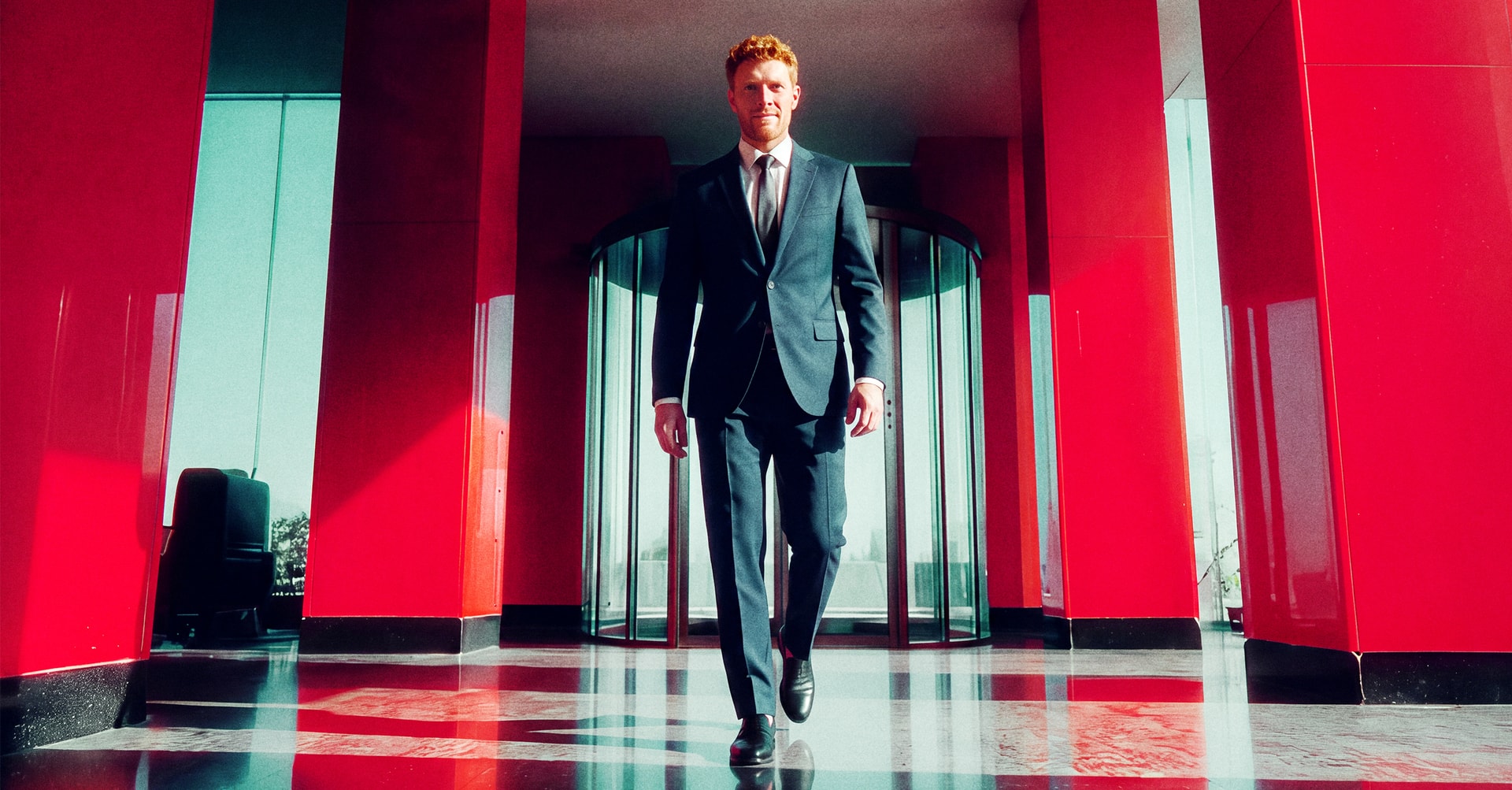 man in suit walking in a building