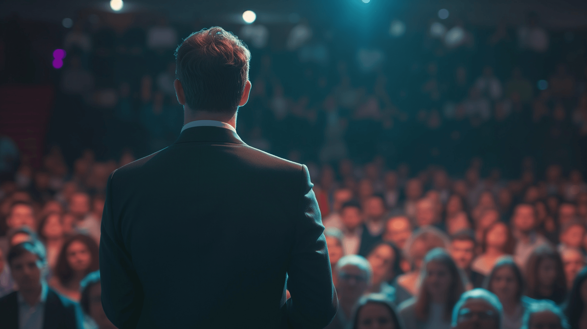A business man on a stage in front of an audience