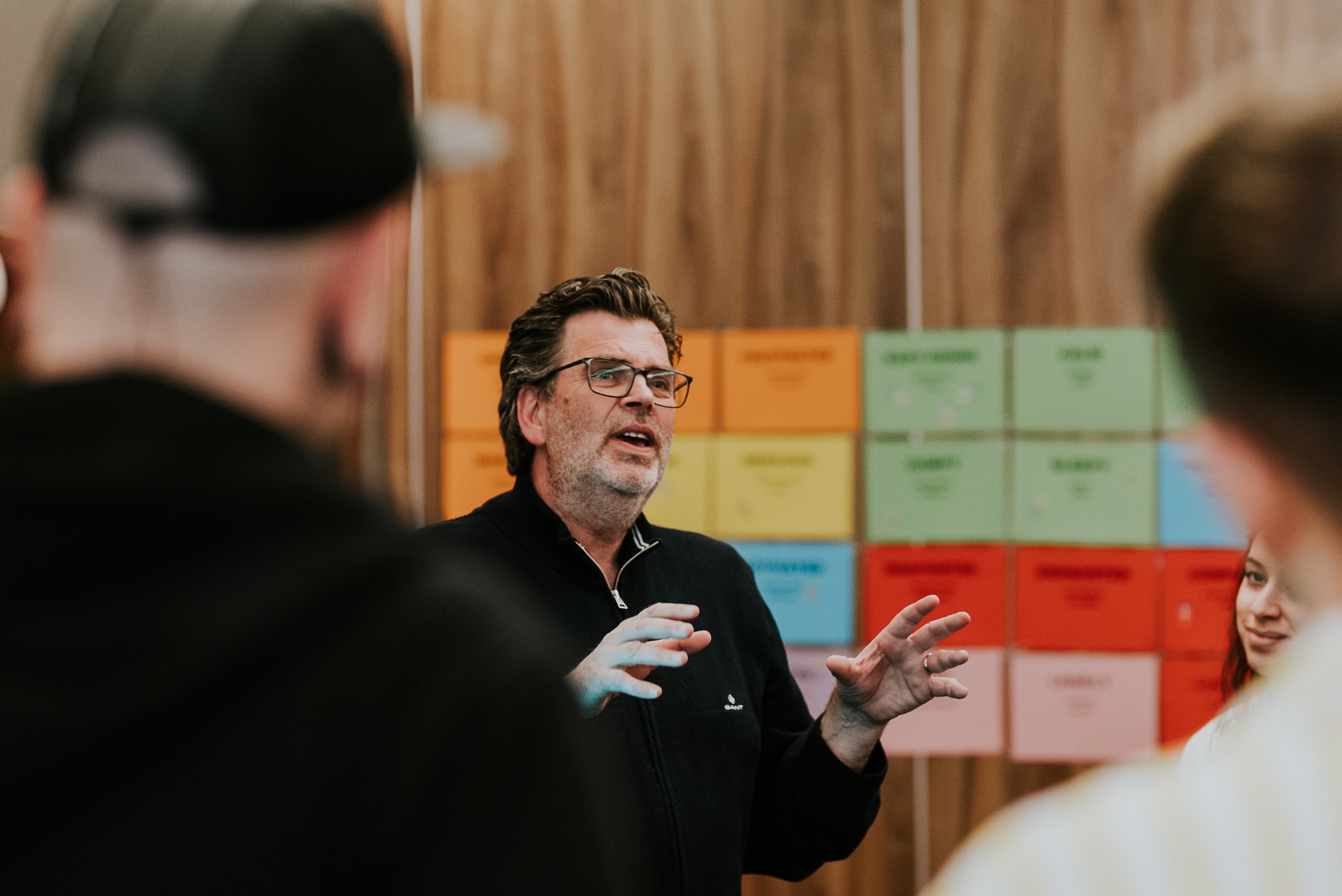 Man advices guides an audience, workshop situation